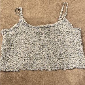 Cropped blue tank with little whit flowers on it.